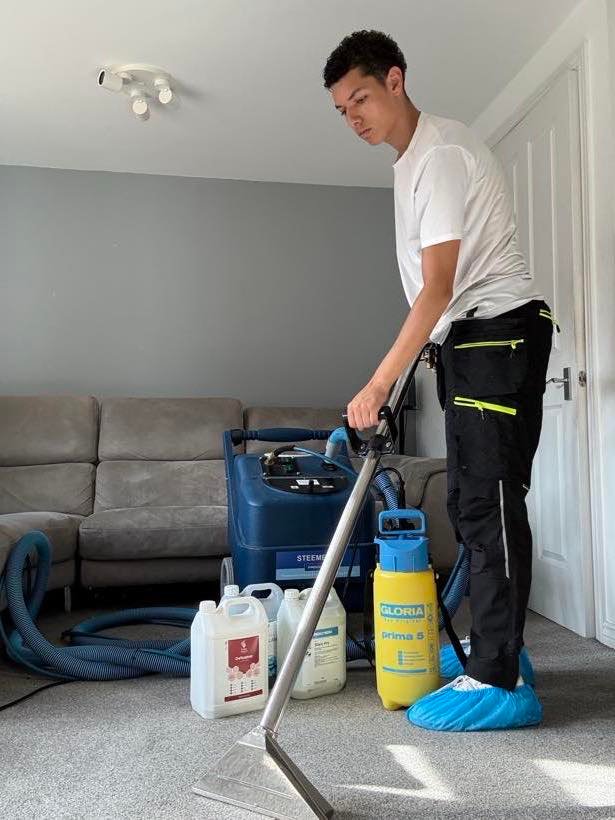 Elijah Hope of Nottingham Carpet Care using hot water extraction equipment